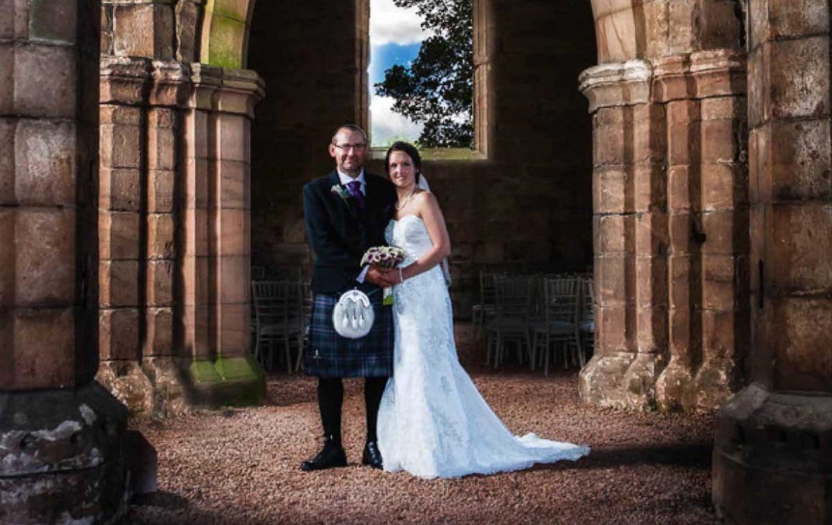 Bride and Groom standing outside Dunglass Estate Church entrance