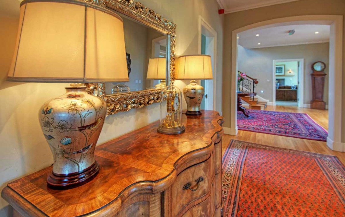 Hallway of Dunglass Estate with persian carpets and antique lamops
