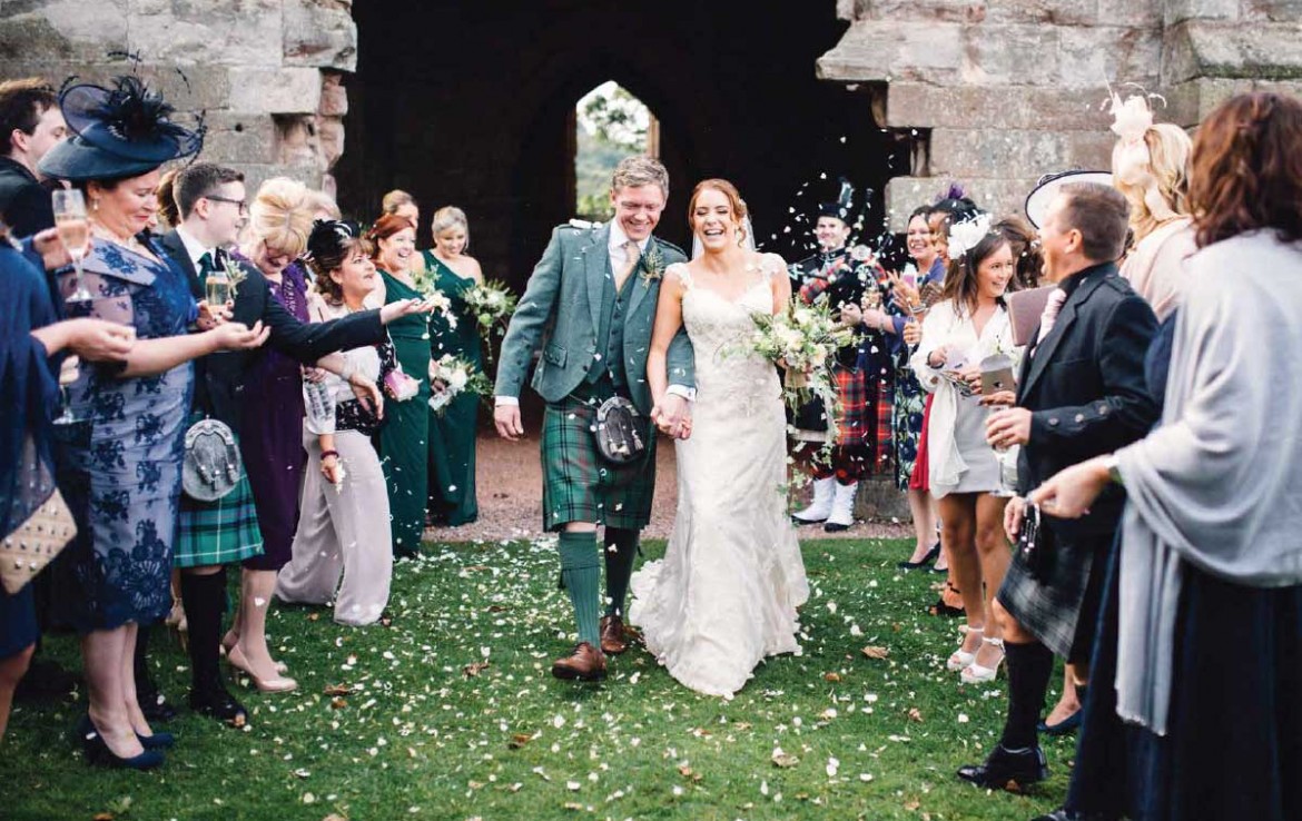 Wedding couple coming out of Dunglass Estate chapel
